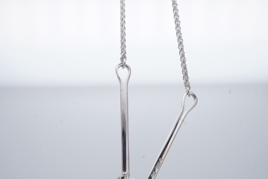 Georg Jensen, a blue topaz necklace, centring on a hook clasp suspending an oval blue topaz pendant, pendant length 5.5cm, necklace length 43cm, stamped GJ for Georg Jensen, 925S and European convention assay marks for s